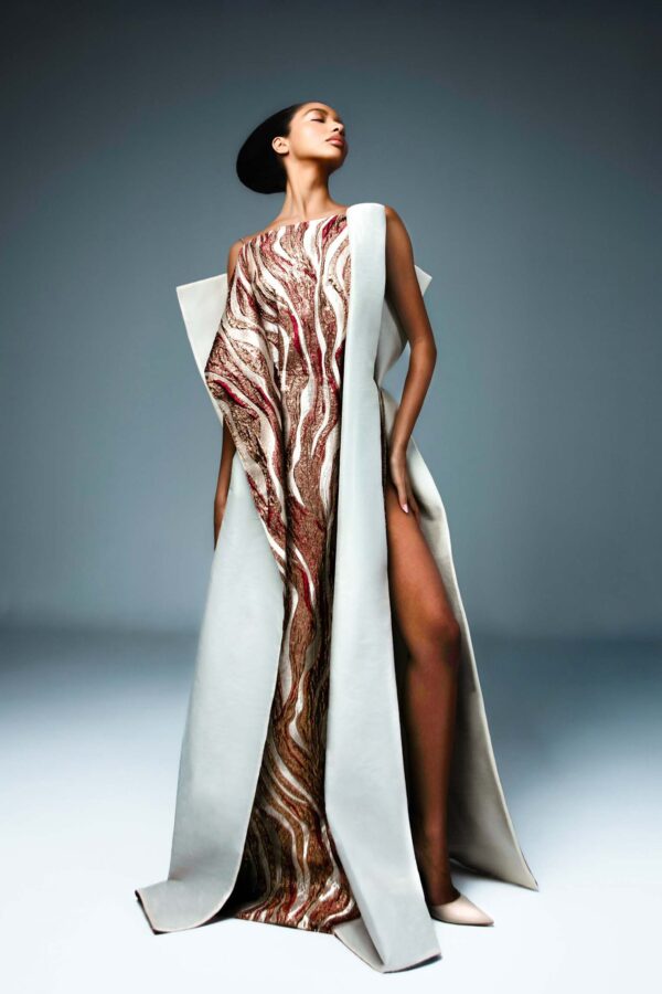 Dusky rose and ivory brocade haute couture gown with elongated side slits and a sculpted open back.